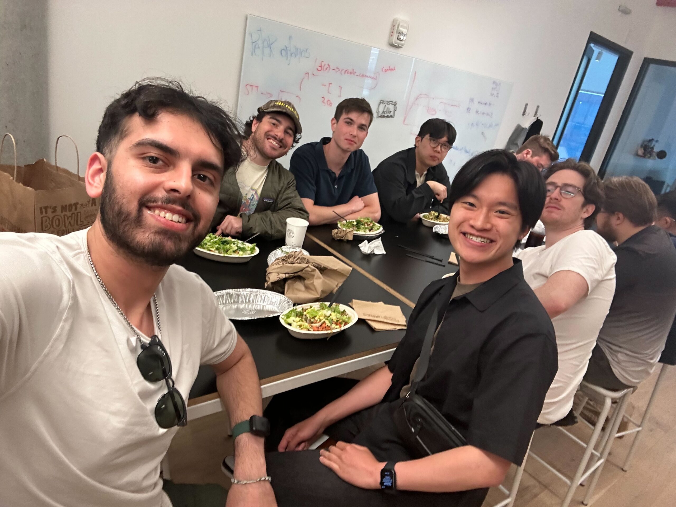 Ronald Leung smiling with coworkers at Rilla.