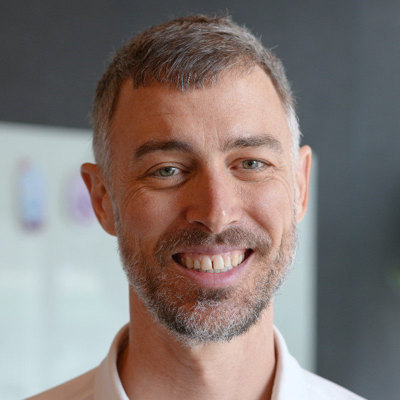 up close photo of man with facial hair and hazel eyes