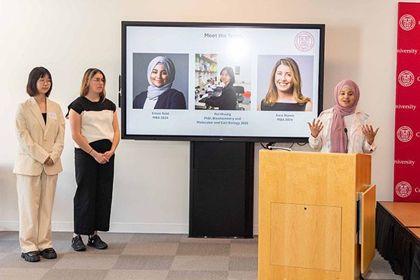 Rui Huang, PhD ’25 , Kara Styers, MBA ’24, and Eman Said, MBA ’24, begin their pitch at the Life Sciences Technology Innovation Fellowship showcase.