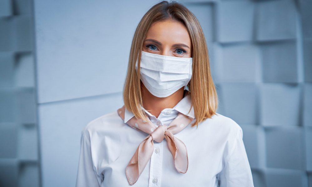 Picture of female receptionist wearing face mask due to covid-19 restrictions