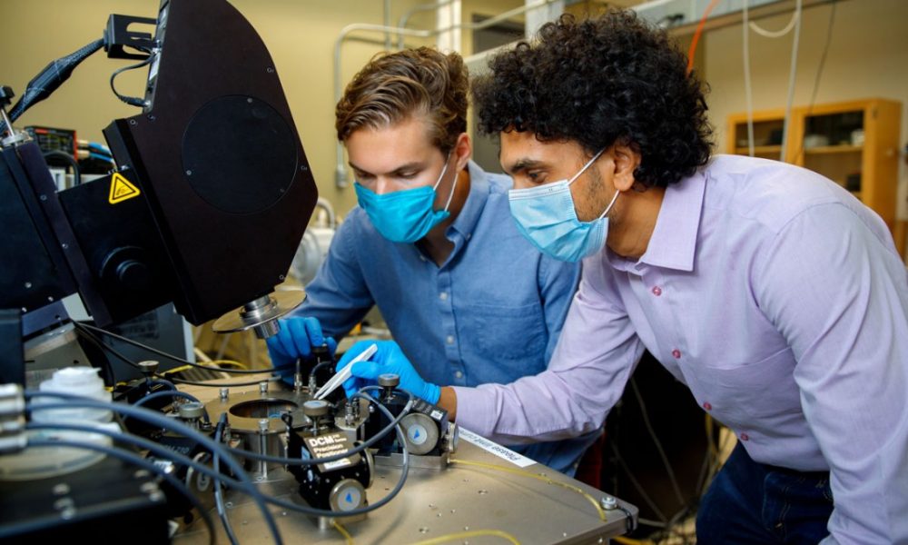 Soctera co-founders Reet Chaudhuri, M.S. ’16, right, and Austin Hickman work on their aluminum nitride-based power amplifier, which produces millimeter-wave frequency signals that can travel farther than existing technology allows.