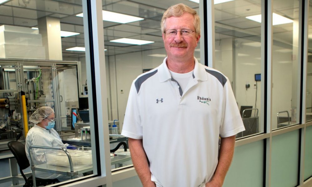 Greg Galvin, M.S. ’82, Ph.D. ’84, MBA ’93, founder and CEO of Rheonix, shown here in 2015, stands outside his lab.