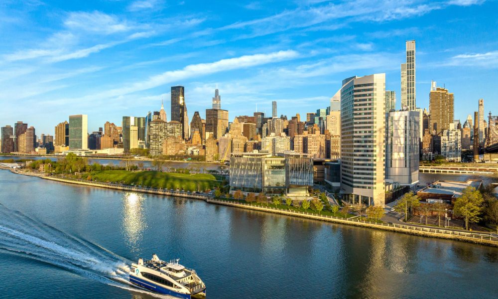 City skyline with riverfront and ferry