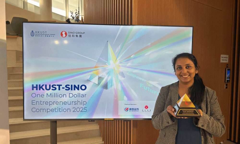 woman standing in front of tv monitor holding pyramid award