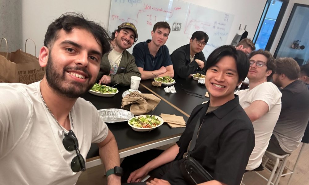 Ronald Leung smiling with coworkers at Rilla.