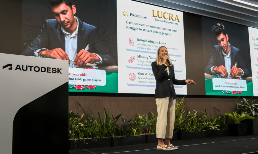Woman on stage with presentation in the background