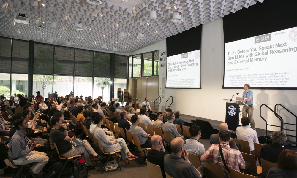 Auditorium full of people watching a presentation