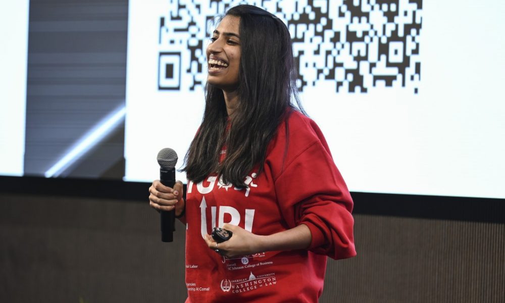 MBA student in red sweater pitching idea