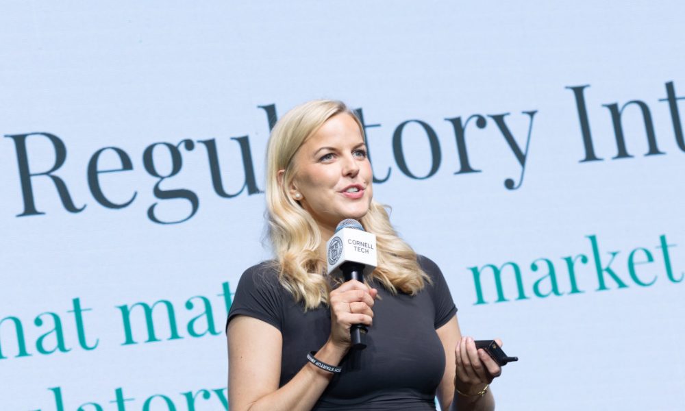Woman with blonde hair holding a microphone