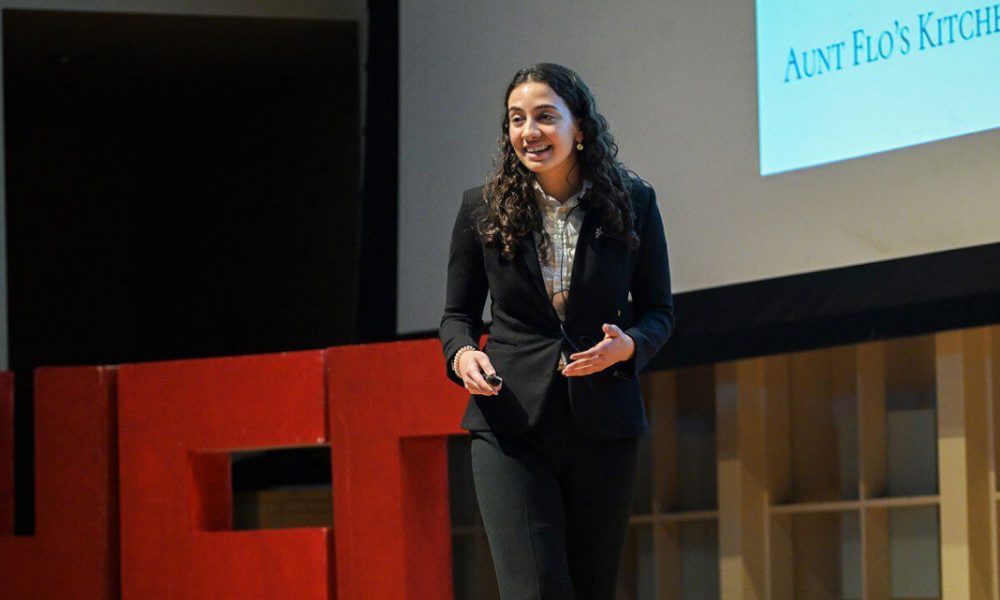Woman in suit speaking on stage
