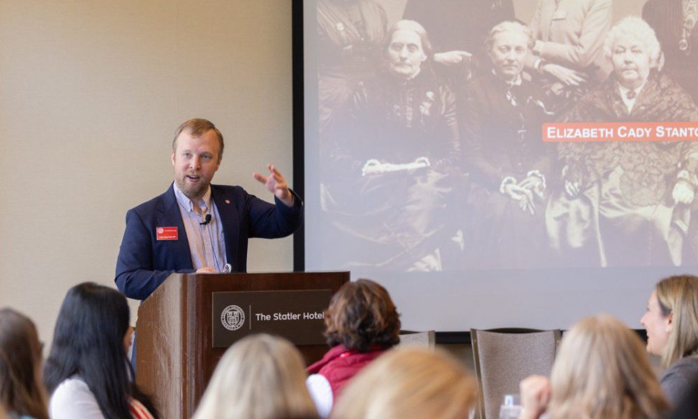 man speaking at a podium to an audience