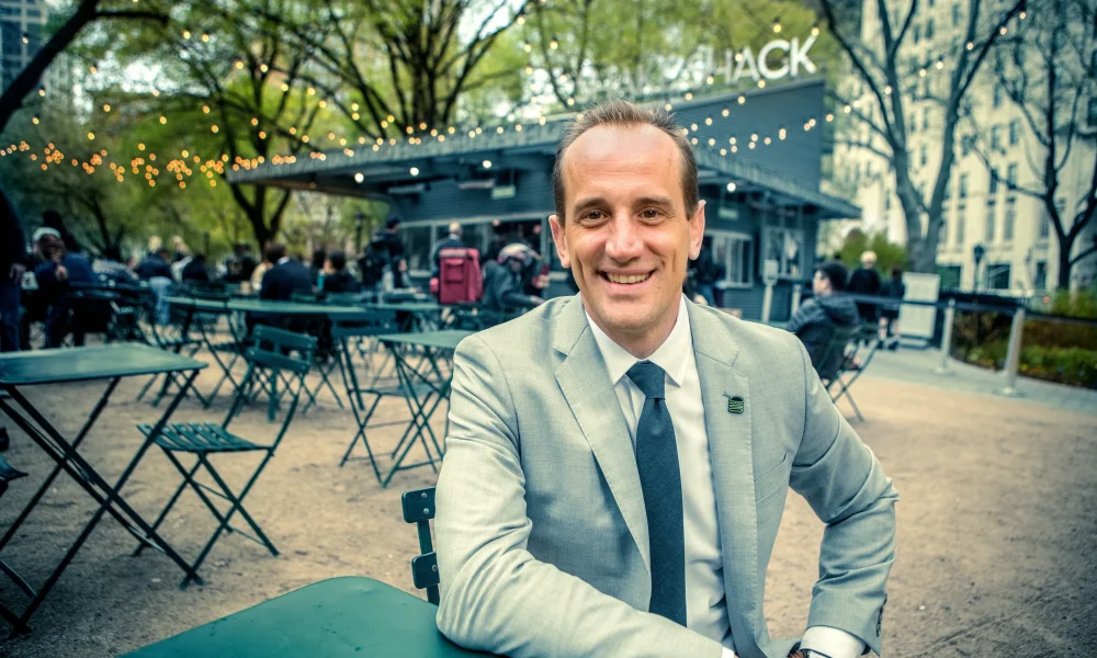 Image of Founder Randy Garutti wearing a gray suit, with an outdoor event in the background