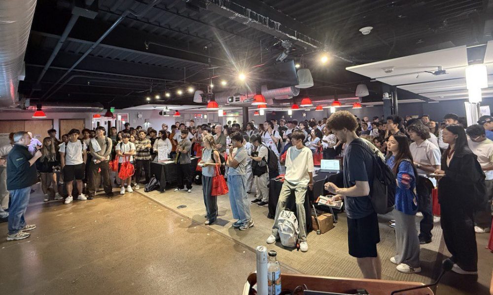 large group of people standing in a room