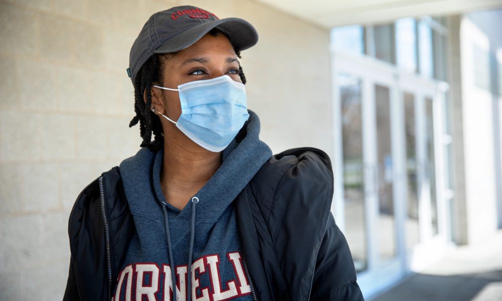 female student wearing mask in Cornell sweatshirt