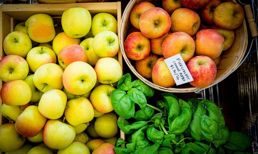 apples and basil in produce crates