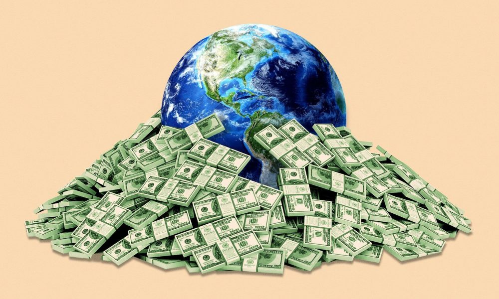 Earth sitting on top of a pile of US bundled dollar bills with a tan background.