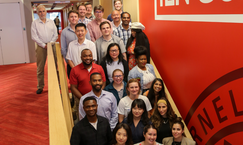 the 2023 JSSA cohort standing on a flight of stairs for a group photo
