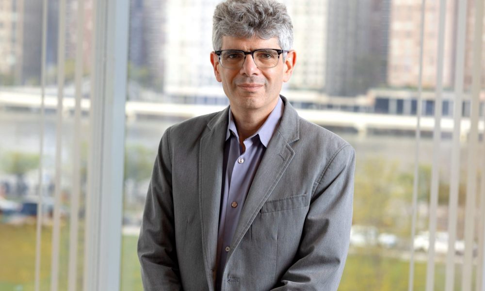 man in glasses and gray suit