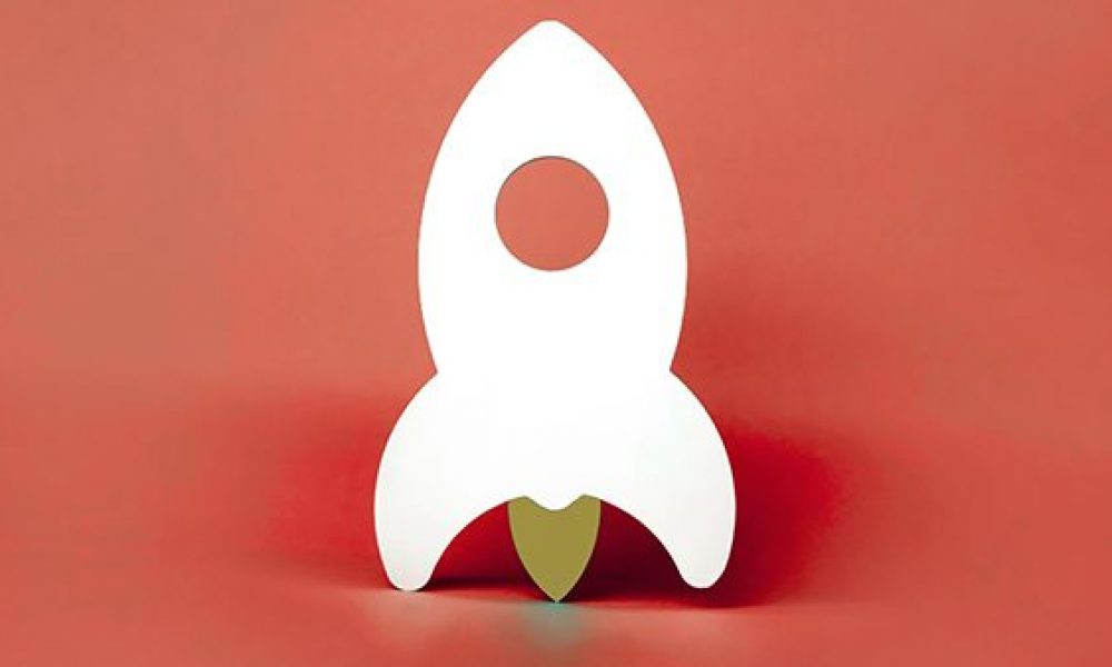 white model rocket on red background