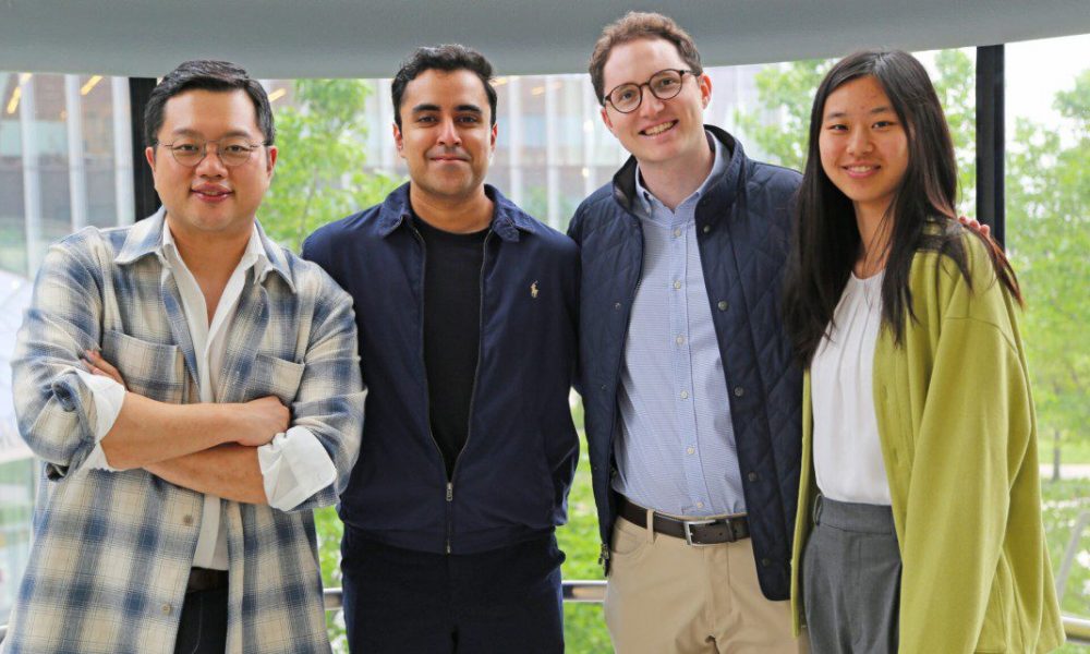 Group of four people standing together