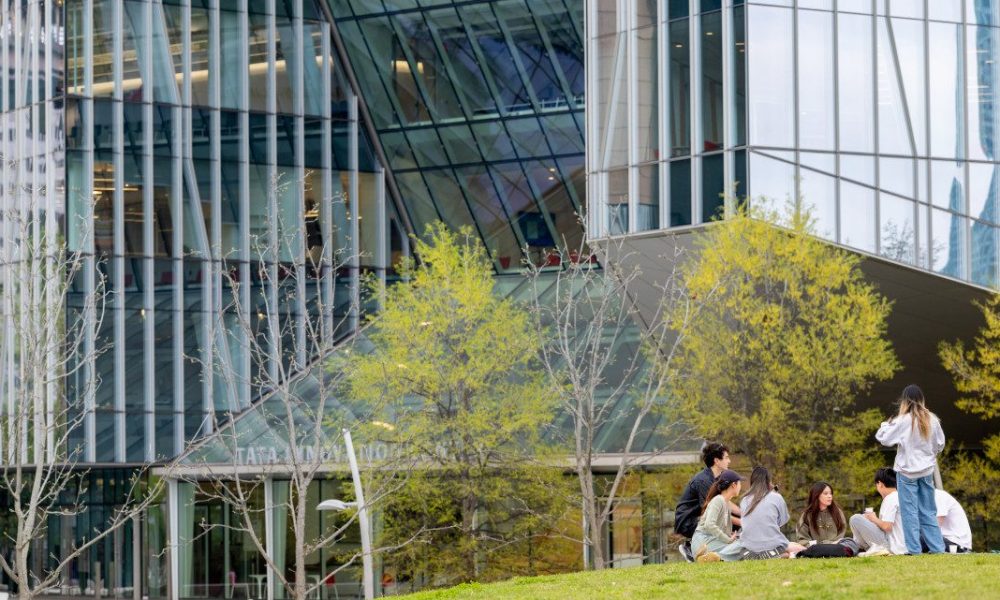 Building with reflective windows and a few trees