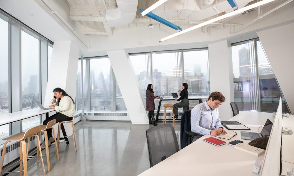 people working in large open white space