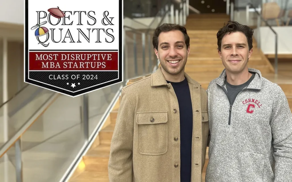 two dark haired men standing in front of staircase