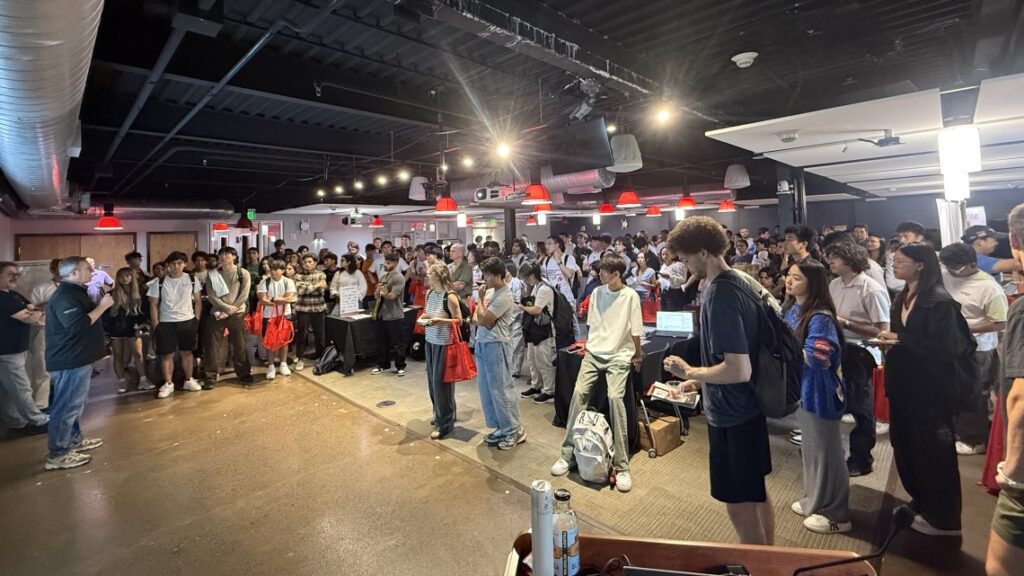 large group of people standing in a room