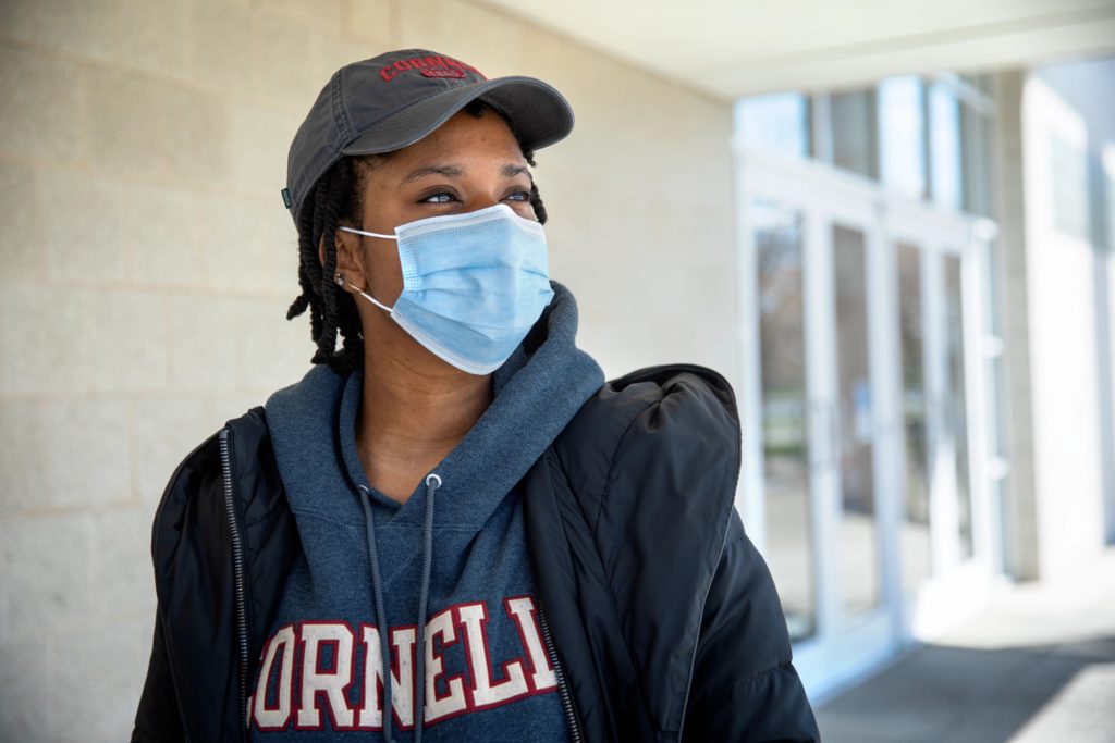 female student wearing mask in Cornell sweatshirt