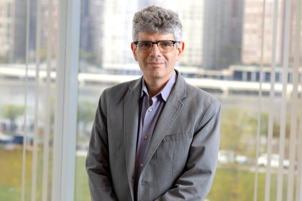 man in glasses and gray suit