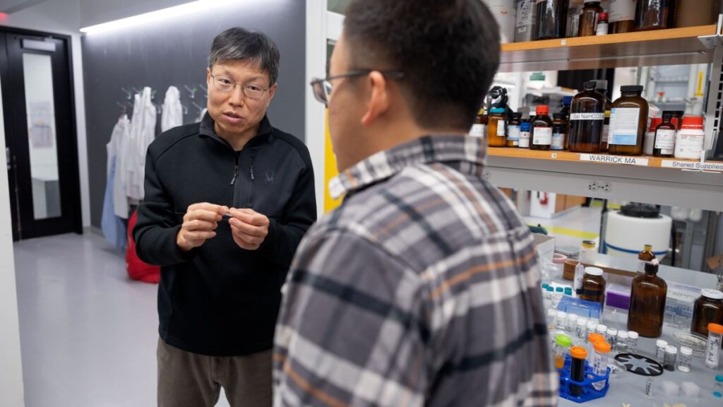 two men talking in science lab