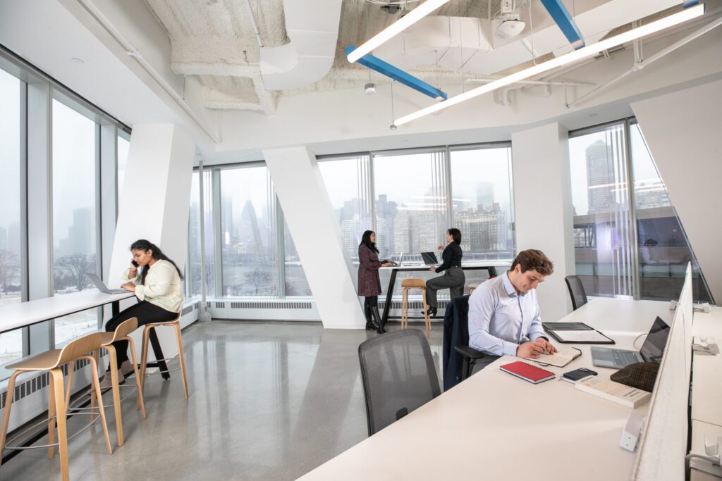 people working in large open white space