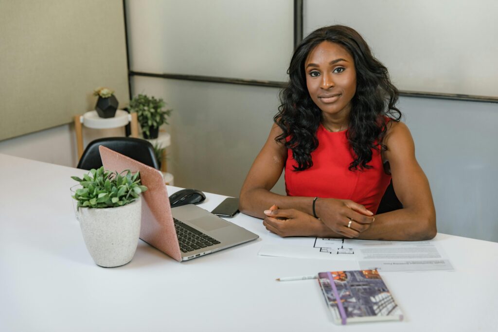 woman sitting at a table with laptop computer open
